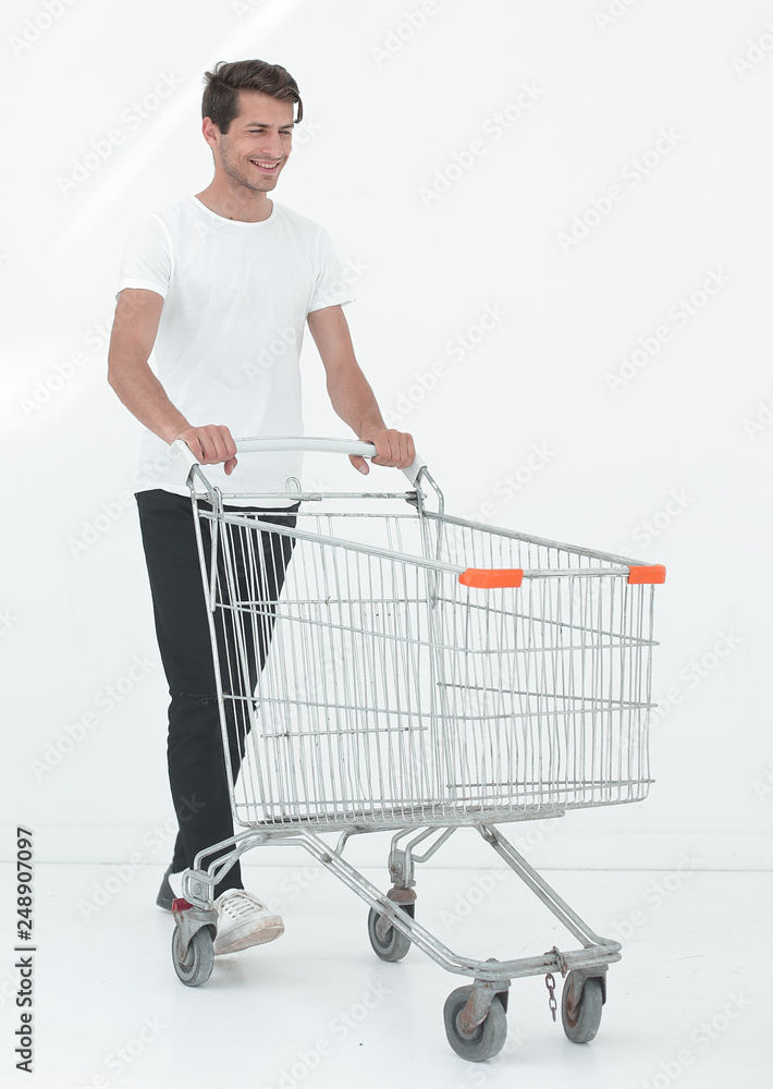 smiling man pushing shopping cart. smiling man pushing shopping cart.