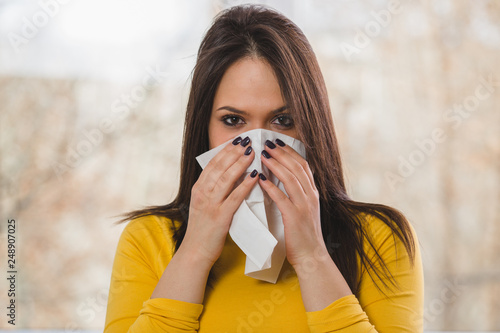woman blowing her nose