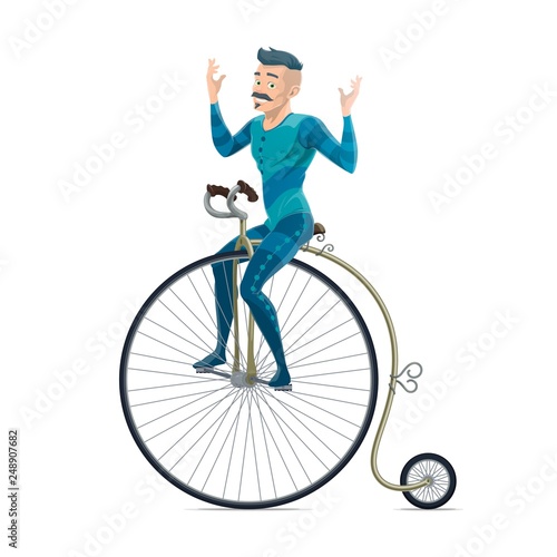 Circus performer riding on retro bicycle
