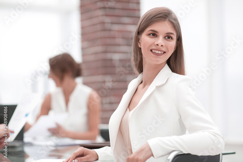 confident young businesswoman sitting at her Desk