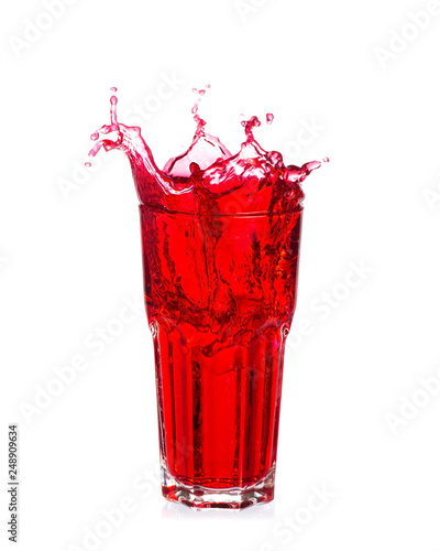 Red soda splash out of a glass isolated on white background.