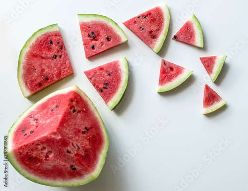 Creative scheme of sliced ​​watermelon on a white background with space for text. Watermelon, isolated on white background. View from above. Background with watermelons