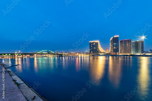Belgrade, Serbia - February 10, 2019: Belgrade Waterfront buildings, old bridge and night panorama with reflection on Sava river.