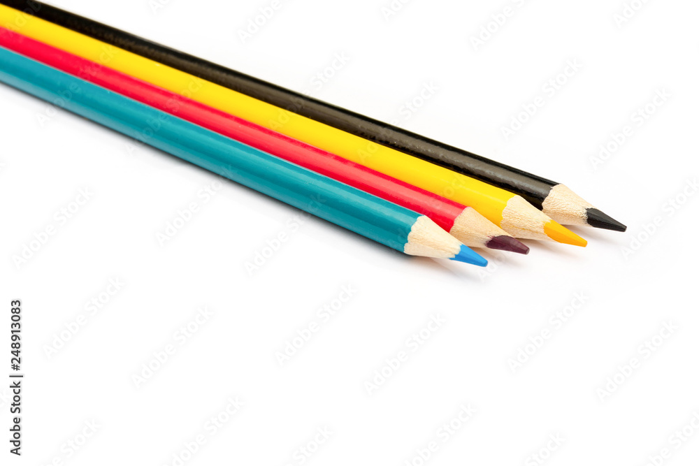 Four colored pencils. The colors cyan, magenta, yellow and black. The concept of polygraphy.