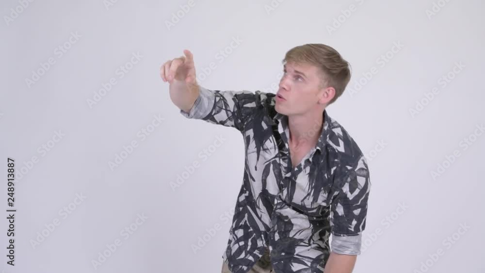 Young handsome tourist man pointing finger Young handsome tourist man pointing finger