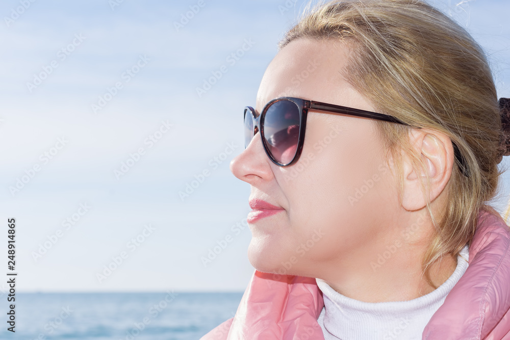 portrait of middle-aged woman outdoors against the sea portrait of middle-aged woman outdoors against the sea