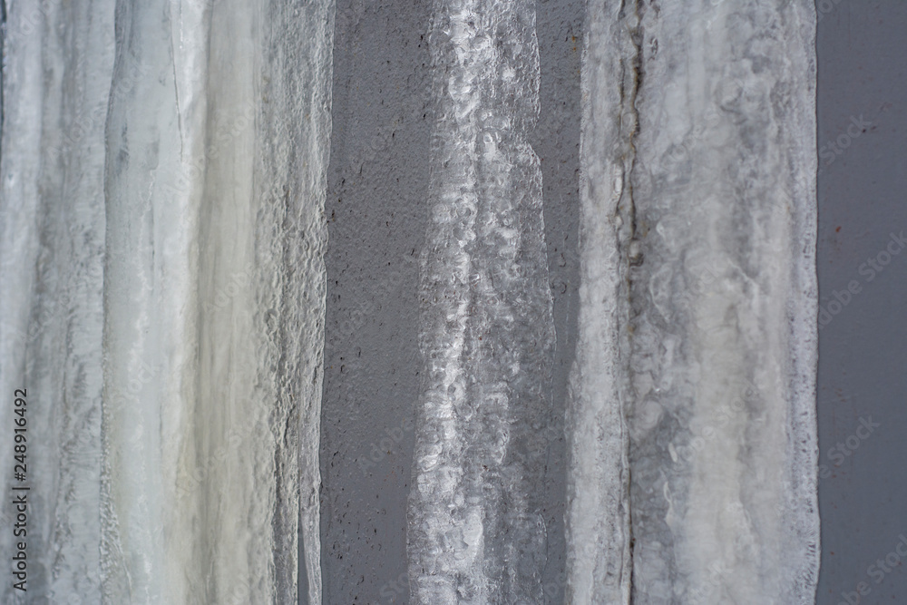 Frozen streams of water on a metal surface Frozen streams of water on a metal surface