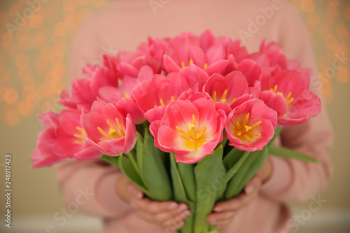 Girl with spring tulips on blurred background  closeup. International Women s Day