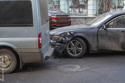 Black passenger car crashed with a broken front end