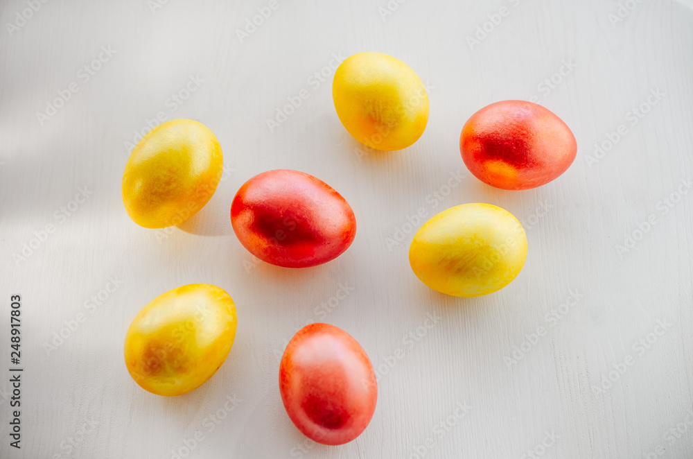 Multi-colored eggs on a white background. Creative Easter concept. Living coral - the color of the year 2019 Multi-colored eggs on a white background. Creative Easter concept. Living coral - the color of the year 2019