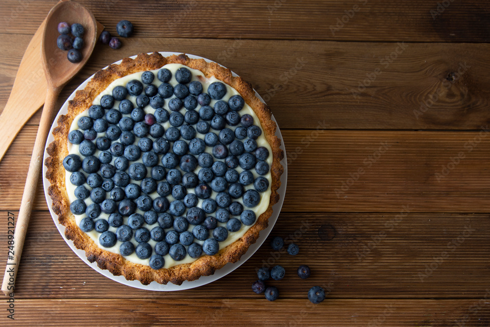 Blueberry Tart or cake with cream and berries. Fresh sweet dessert with fruits. homemade food, wooden, rustic background. Copy space. Blueberry Tart or cake with cream and berries. Fresh sweet dessert with fruits. homemade food, wooden, rustic background. Copy space.