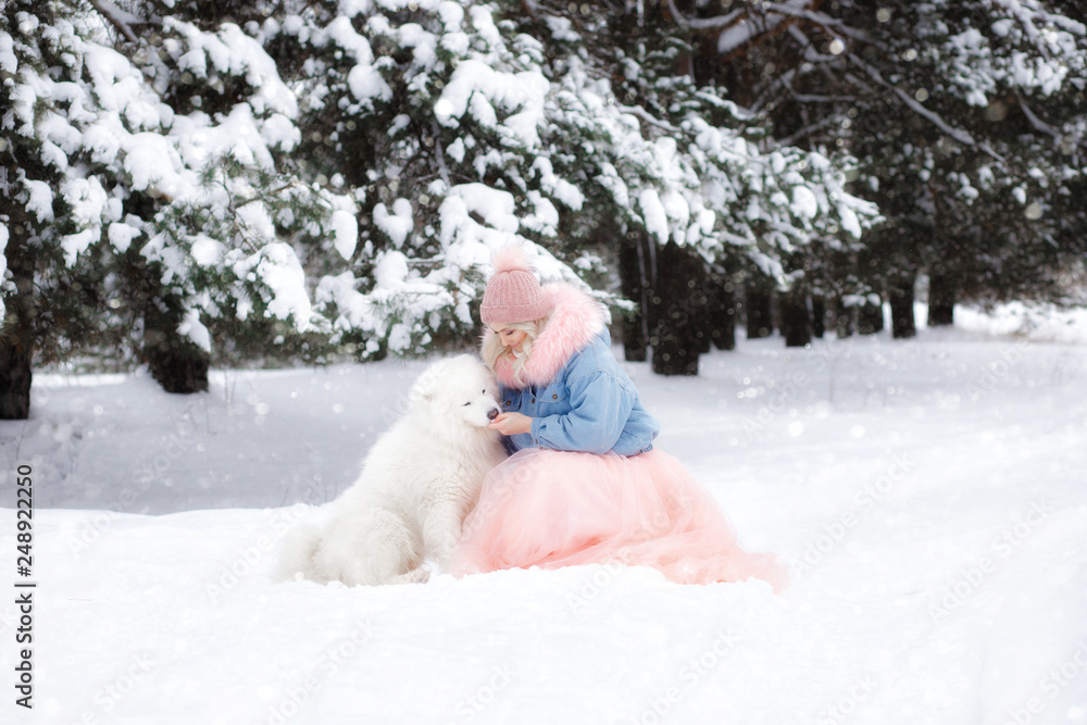 beautiful girl with a dog on a walk in the winter forest. beautiful girl and her pet. beautiful girl with a dog on a walk in the winter forest. beautiful girl and her pet.