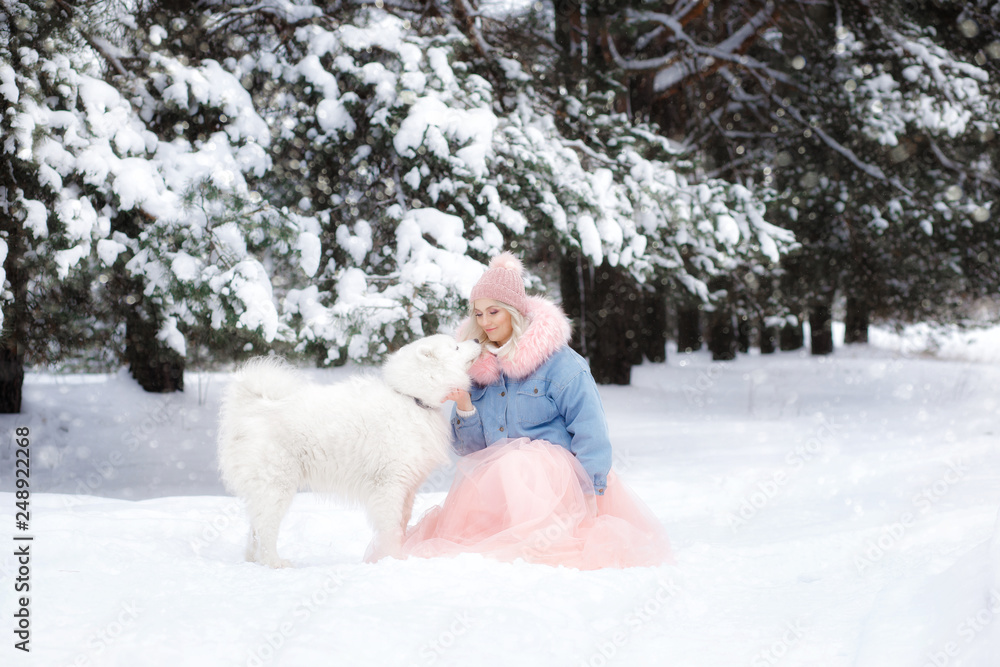 beautiful girl with a dog on a walk in the winter forest. beautiful girl and her pet. beautiful girl with a dog on a walk in the winter forest. beautiful girl and her pet.