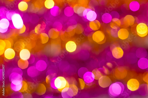 Abstract blurred background with bright bokeh pink and orange colors_