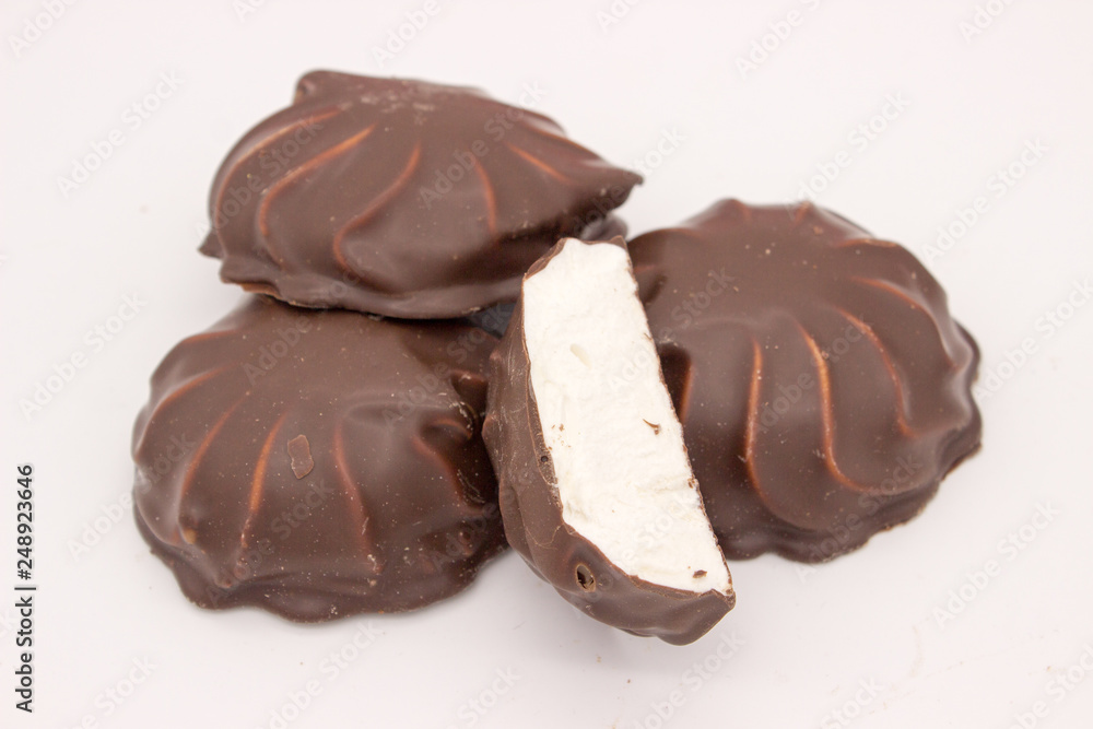 Marshmallows in chocolate. The isolated image on the white background. Marshmallows in chocolate. The isolated image on the white background.