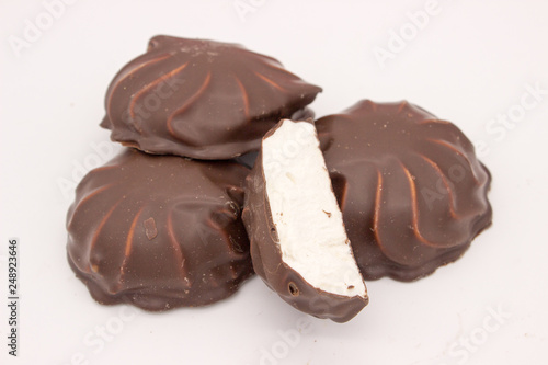 Marshmallows in chocolate. The isolated image on the white background.