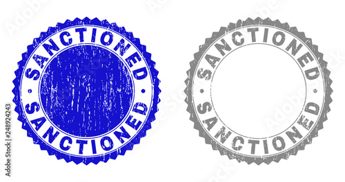 Grunge SANCTIONED stamp seals isolated on a white background. Rosette seals with grunge texture in blue and gray colors. Vector rubber stamp imitation of SANCTIONED text inside round rosette.