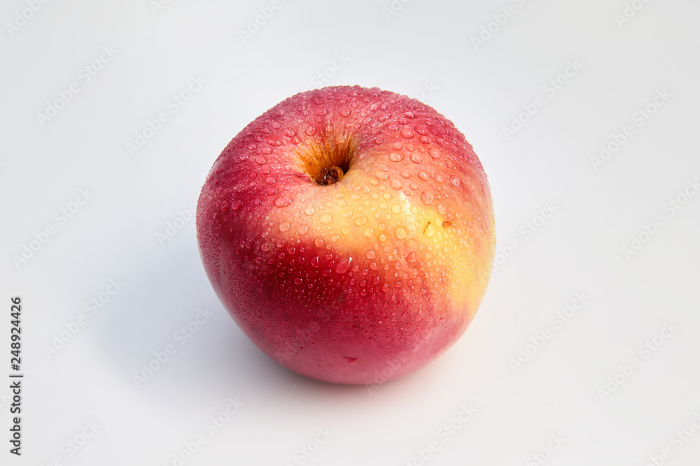 Red Apple in water drops on white background Red Apple in water drops on white background