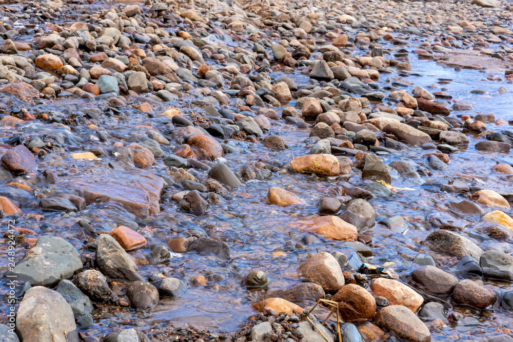 Melt water flows over stony slope in spring Melt water flows over stony slope in spring