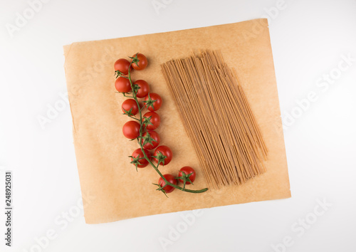 Raw pasta with ingredients for cooking isolated on white background, top view. Copy space for Text, flat lay