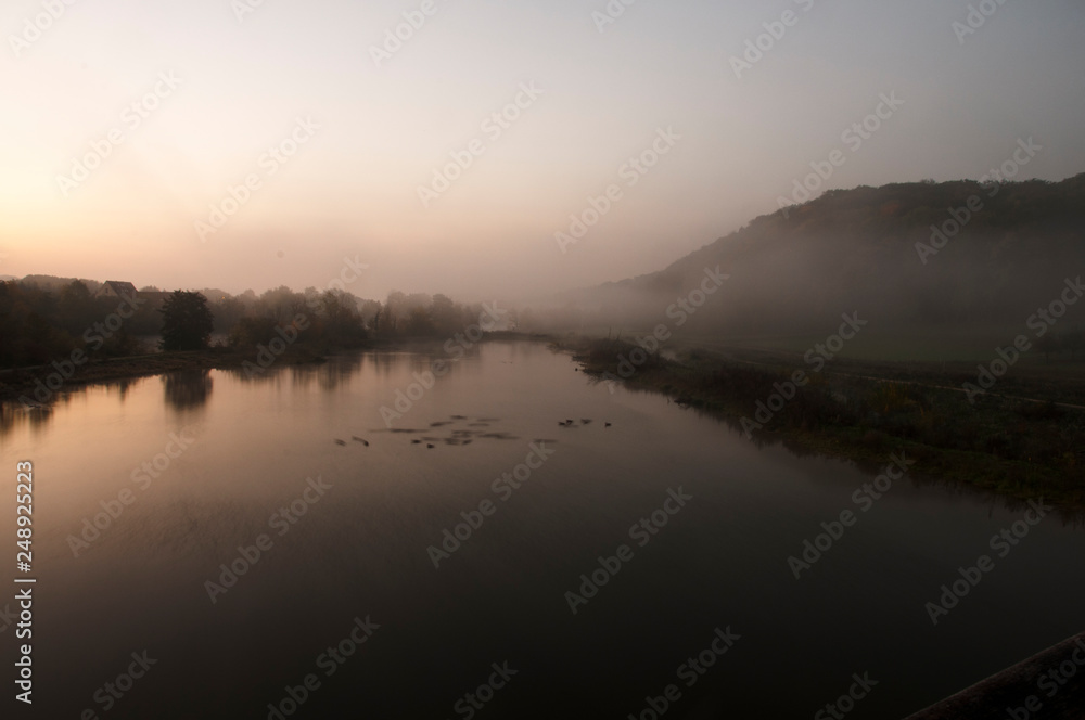 The river Neckar at an early cold morning with fog over the water