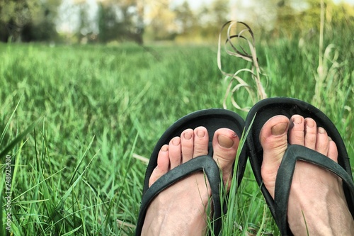 feet in slippers on the grass