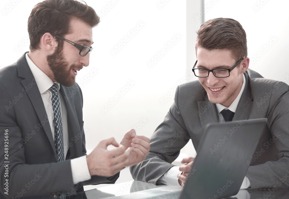 business colleagues discuss something sitting at the Desk business colleagues discuss something sitting at the Desk