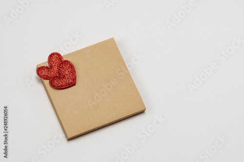 Sticky brown paper notes with a heart. On a white background. Valentine's Day