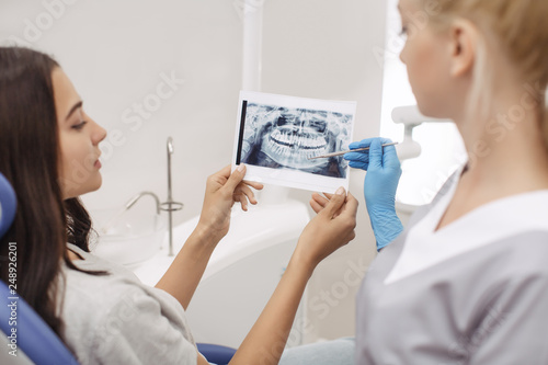 Dentist showing X-ray image to patient