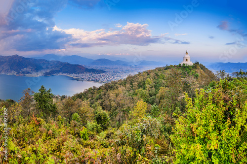 World Peace Pagoda (or Stupa), Pokhara and Phewa lake panorama, against sunset sky and Himalaya range with mt. Annapurna and mt. Machapuchare.