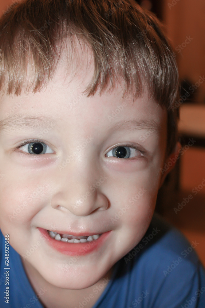 Portrait of a smiling little boy close up. Positive smiling child posing in his room. Funny kid is pretty smiling Portrait of a smiling little boy close up. Positive smiling child posing in his room. Funny kid is pretty smiling