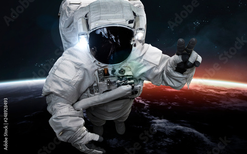 Fototapeta Naklejka Na Ścianę i Meble -  Astronaut at spacewalk. Science fiction art. Elements of this image furnished by NASA