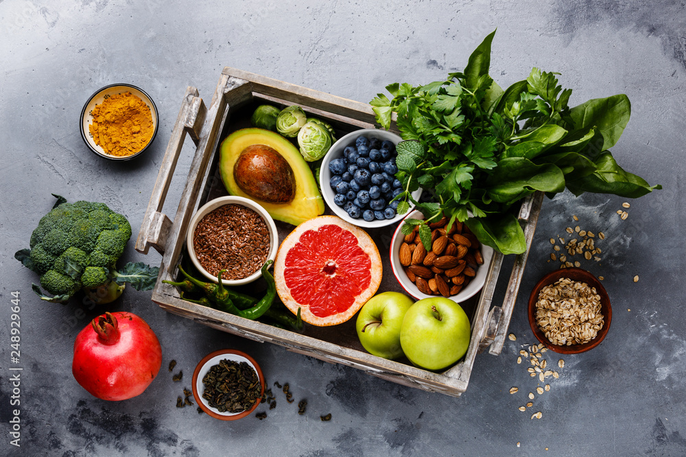 Healthy food clean eating selection in wooden box: fruit, vegetable, seeds, superfood, cereals, leaf vegetable on gray concrete background - obrazy, fototapety, plakaty 