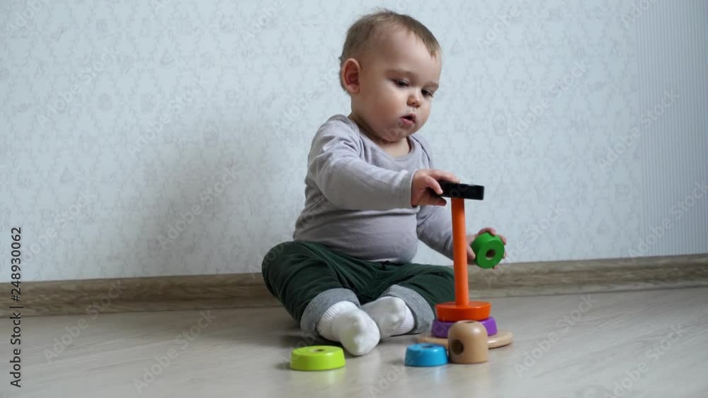 Little cute baby playing with colorful child pyramid Little cute baby playing with colorful child pyramid