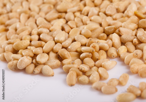 Pile of delicious pine nuts on a white surface