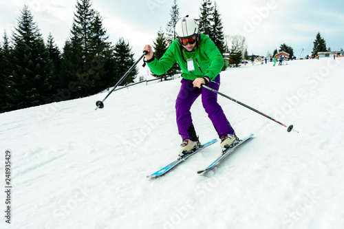 A man in a professional outfit rushes from the mountain skiing in the Ukrainian mountains