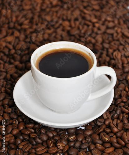 cup of coffee with beans background © millenks