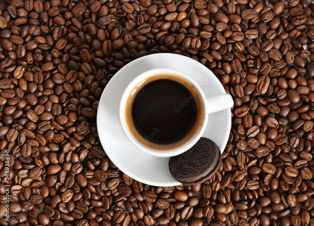 cup of coffee and cookie with beans background cup of coffee and cookie with beans background
