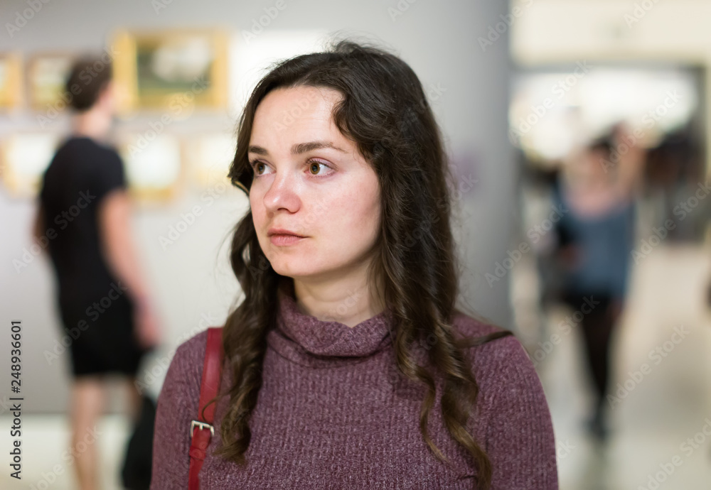 Fototapeta premium Woman visiting museum and thinking indoors