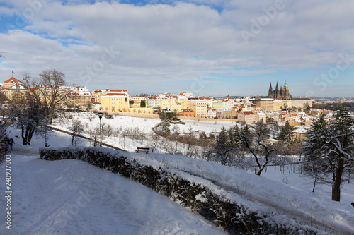 Snowy Prague City with gothic Castle from Hill Petrin in the sunny Day, Czech republic