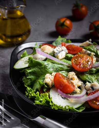 Fresh green salad with blue cheese, onions and cherry tomatoes