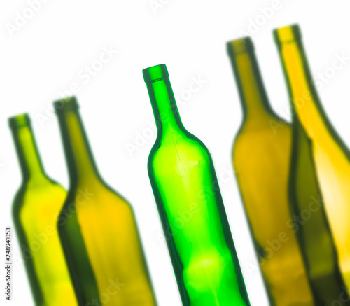 ABSTRACT IMAGE OF GROUP OF FIVE GREEN WINE BOTTLES ON WHITE BACKGROUND