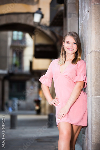 City portrait of woman near old wall