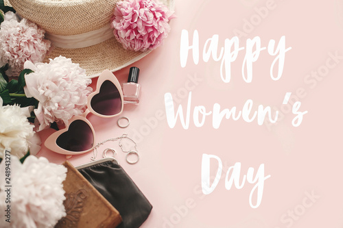Happy Women s Day text sign at stylish girly pink retro sunglasses peonies  jewelry  hat  purse cosmetics on pastel pink paper flat lay. Girl Power. International womens day  8 march