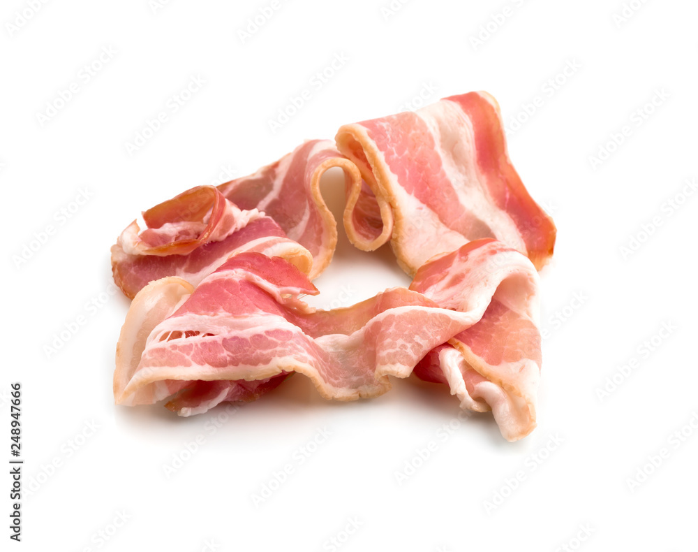 Slices of bacon on a white background. Raw bacon closeup on a white background. Slices of bacon on a white background. Raw bacon closeup on a white background.