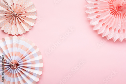 Chinese paper fans in pastel colors on pink table  top view  copy space for text  selective focus