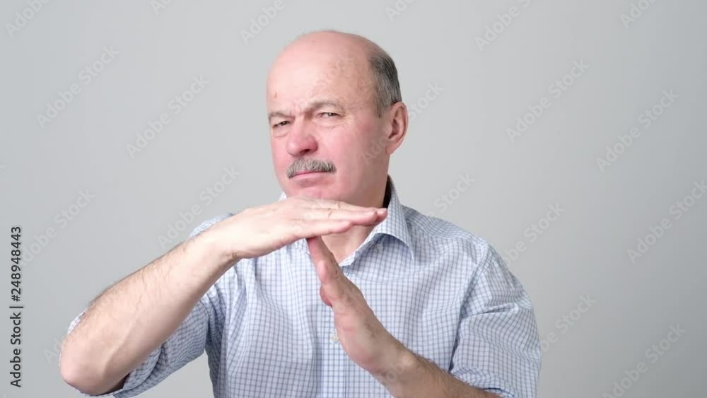 Senior man giving showing time out hands gesture Senior man giving showing time out hands gesture
