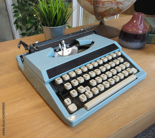 Old typewriter and globe on the desk