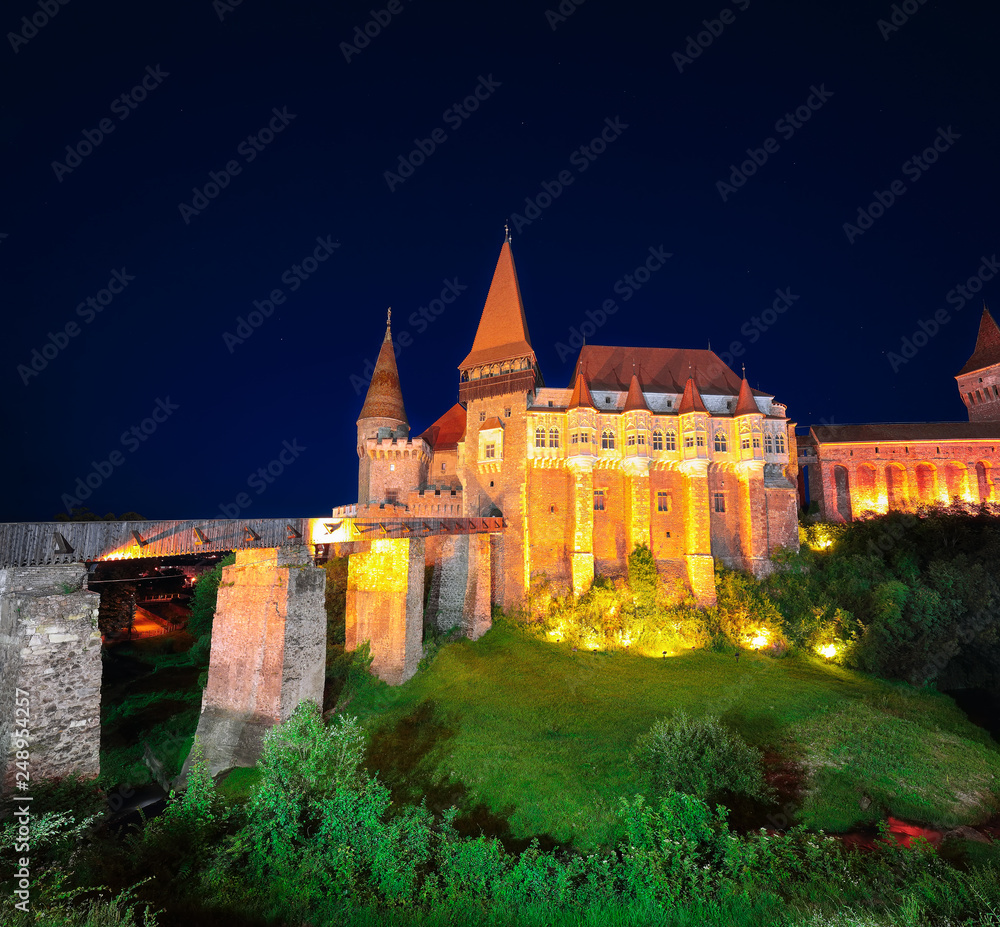 Beautiful night panorama of the Hunyad Castle / Corvin's Castle with wooden bridge