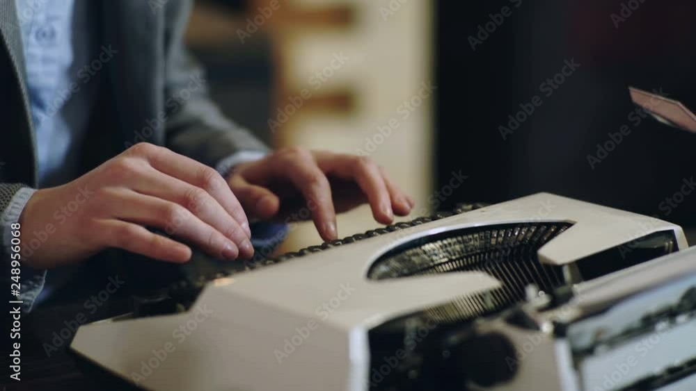 4k. Hands typing a film script or a book on a vintage typewriter. Close-up of hands typing on a vintage typewriter machine. Old typewriter close-up. 4k. Hands typing a film script or a book on a vintage typewriter. Close-up of hands typing on a vintage typewriter machine. Old typewriter close-up.